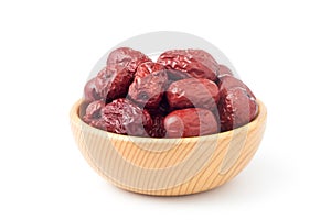 Dried red dates in a wooden bowl