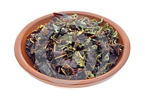 Dried red and green bell peppers in a small bowl