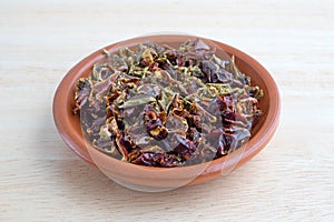 Dried red and green bell peppers in a small bowl