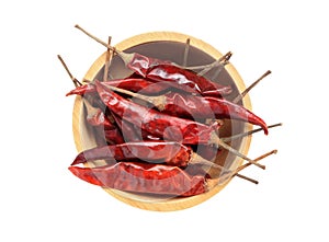 Dried red hot chili pepper in wooden bowl isolated on white background.