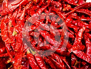 Dried red hot chili on wooden plate, Food ingredient for spicy recipe.