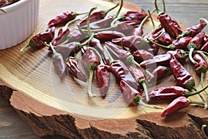 Dried red hot chilly peppers, very spicy on wooden table.