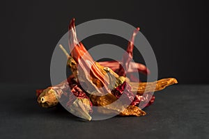Dried red and yellow chilies on dark background