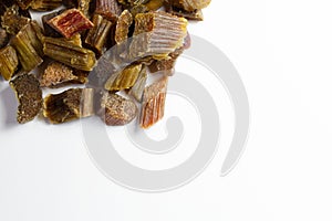 Dried rhubarb candied fruits. Candied rhubarb on a white background. Dry rhubarb close - up macro photography. Rheum