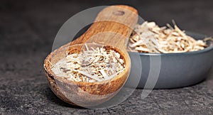 Dried root of siberian ginseng on dark background - medicine alternative photo