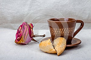 Dried rose, broken heart cookies, cup of coffee