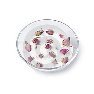 Dried rose buds in a glass cup with white sugar