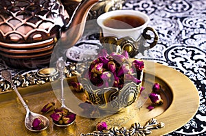 Dried rose buds in a metal Cup