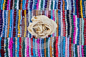 Dried rose in Colorful background. multicolored background. Handmade carpet. Craft rug