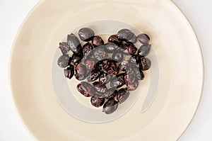 Dried rose hips in heart shape on the plate, Valentine's day