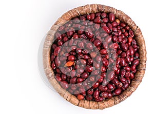 Dried rose hips in wicker basket isolated on white background