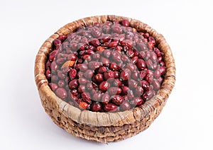 Dried rose hips in wicker basket isolated on white background