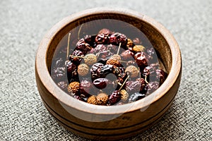 Dried Rosehips in wooden bowl. / kusburnu photo