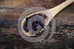Dried roselle isolated on the wooden background.