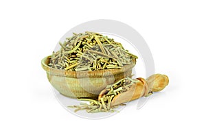 Dried rosemary leaves in a wooden cup with a spoon for spices isolated on a white background. Collection of spices and