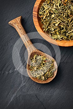 Dried rue leaves in the spoon - Ruta graveolens