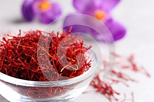 Dried saffron and crocus flowers on light table, closeup. Space for text