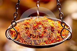 Dried saffron spice in vintage bowl weights