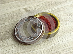 Dried saffron stigmas into handcraft box photo