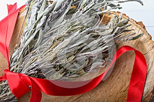 Dried sage branches, sage hot tea, on a piece of natural wood, natural remedies, natural medicine