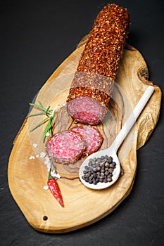 Dried salami crusted in ground red pepper