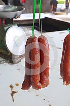 Dried sausage hanging with green rope