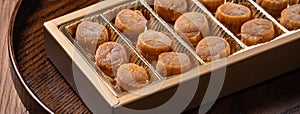 Dried scallop on wooden table