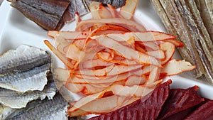 Dried Seafood Mix with Squid, Dried Codfish Caviar, Tuna, Yellow Minke, Dried Caviar. Top View. Cured Dehydrated Fish