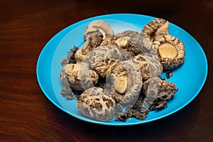 Dried Shiitake Mushroom on blue plate. Healthy food menu. Vegetarian food