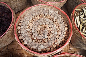 Dried Siam Cardamom in bamboo basket. medicinal plants. Thai herbs. photo