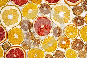 Dried slices of various citrus fruits on white background