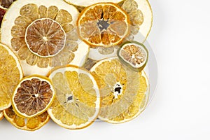 Dried slices of various citrus fruits on white background