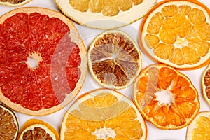 Dried slices of various citrus fruits on white background