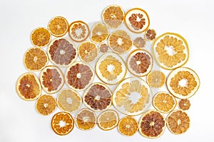 Dried slices of various citrus fruits on white background