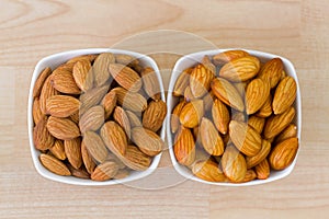 Dried and soaked Shelled Almond on wooden background