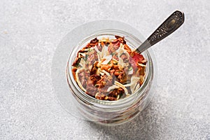 Dried spices, sun-dried tomatoes, dried carrots, Basil and herbes de Provence in a glass jar Copy space