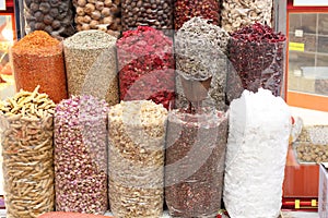 Dried spices in transparent packages standing on the counter in the street market in Dubai