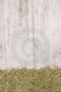 Dried straw grass on a rustic wooden background