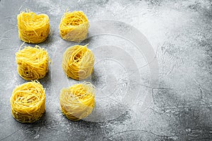 Dried taglierini , on gray stone background, with copy space for text