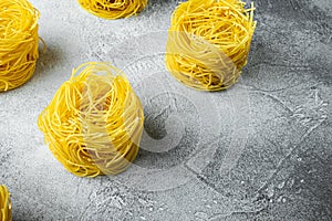 Dried taglierini , on gray stone background, with copy space for text