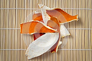 Dried tangerine peel on bamboo background