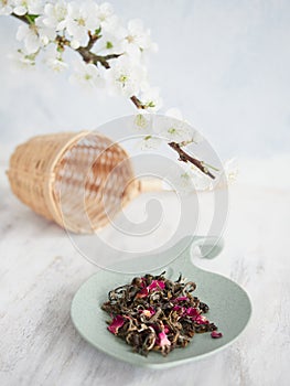 Dried tea leaves for infusion with dried pink flower petals