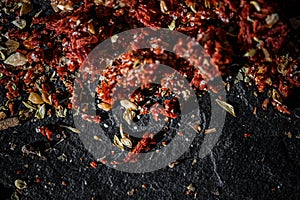 Dried tomato and chili pepper closeup on luxury stone background as flat lay, dry food spices and recipe ingredient