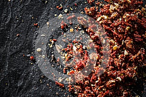 Dried tomato and chili pepper closeup on luxury stone background as flat lay, dry food spices and recipe ingredient