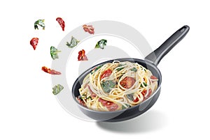 Dried tomato spinach Pasta in a pan on a white isolated background