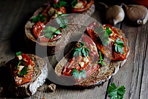 Dried tomatoes bread with oil, garlic and parsley, autumn traditional italian food