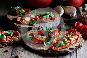 Dried tomatoes bread with oil, garlic and parsley, autumn traditional italian food