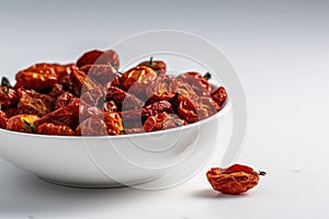 Dried Tomatoes In A White Bowl On A White Background. Generative AI