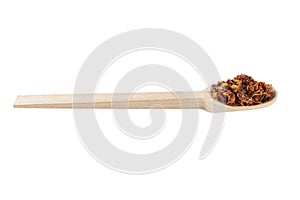 dried tomatoes in wooden spoon isolated on white background. spices and food ingredients. spices and food ingredients
