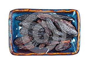 Dried tonka beans on rectangular plate cutout